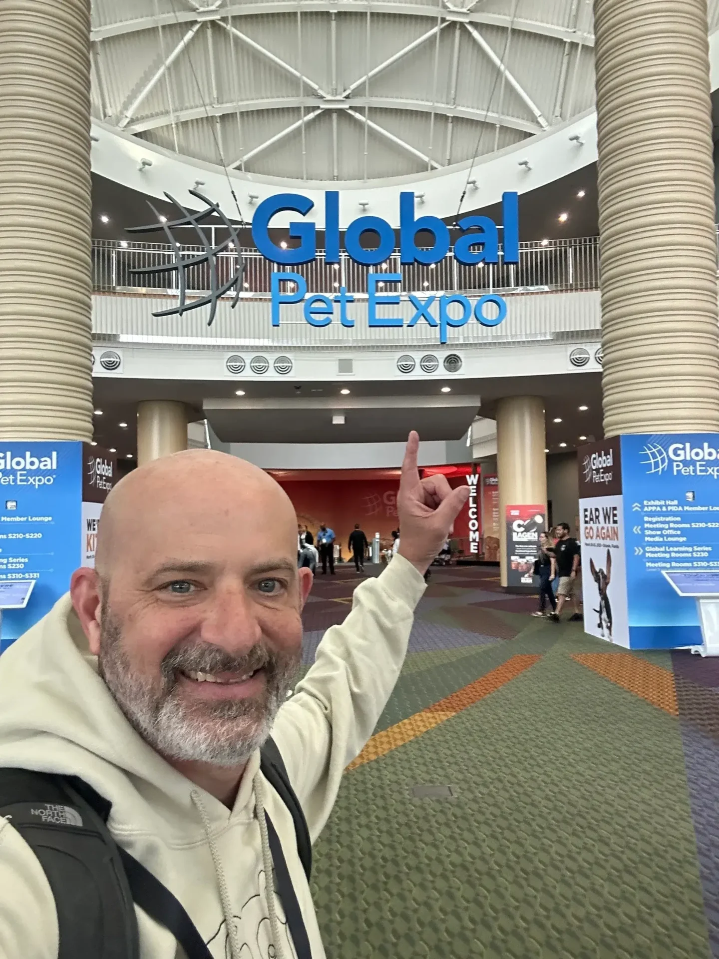 A man in front of the entrance to a convention hall.